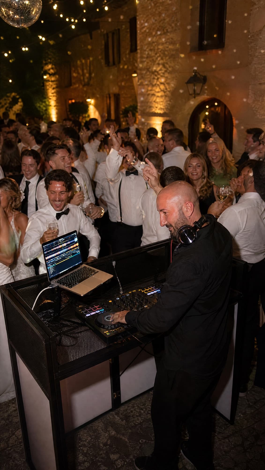 Wedding guests dancing in a courtyard